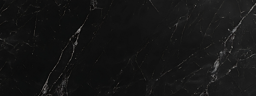 Close-up of a black marble-look wall panel with white veining